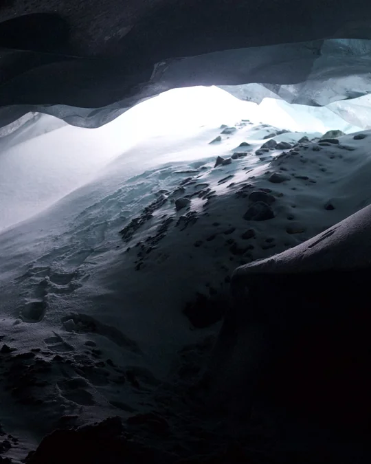Slide 7: Middle section of the cavern opening into bright snow