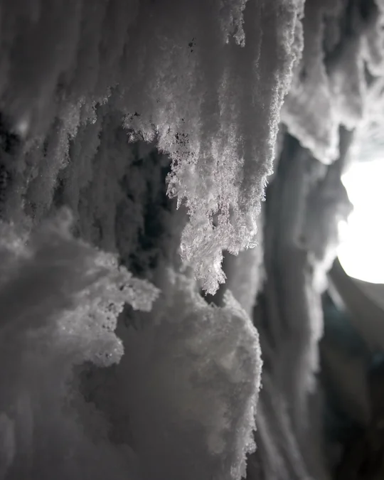A close view of frost hanging from the edge of the ice