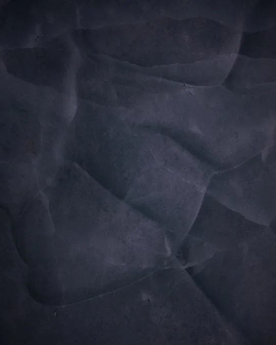 Overlapping facets in dark blue glacier ice